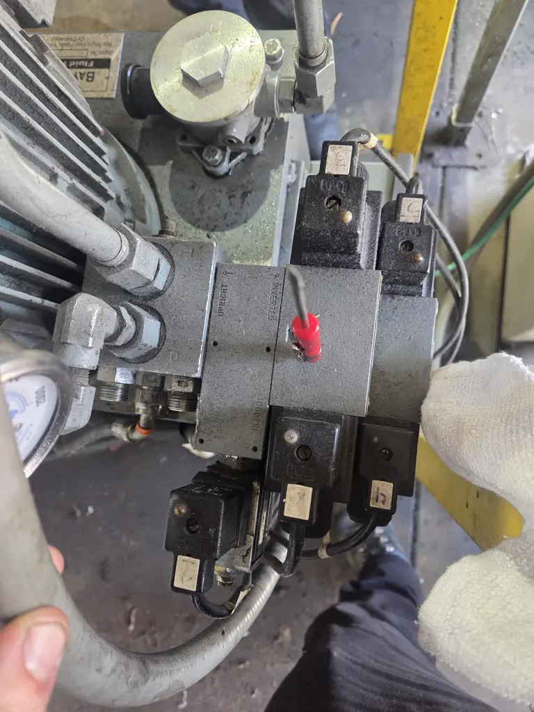 Hydraulic valve manifold with solenoids open for repair on a work truck