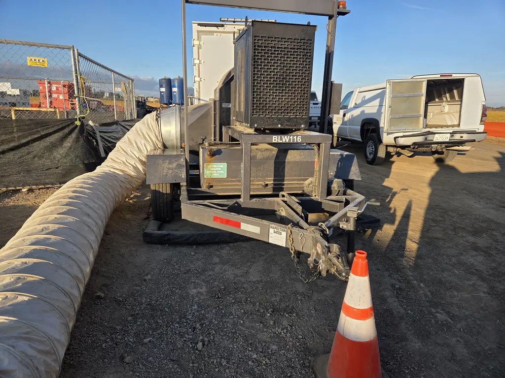Towable equipment trailer being serviced on a job site